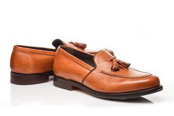 Closeup View of Pair of Traditional Formal Stylish Light Brown Polished Calf Leather Tassel Loafer Shoes Placed On Pure White.