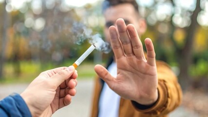 Person refusing cigarette outdoor