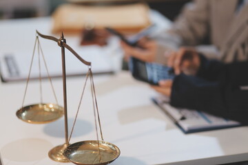 Judge gavel with Justice lawyers having team meeting at law firm background. Concepts of Law and...