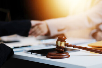 Lawyer shaking hands with a client making about documents, contracts, agreements, cooperation...