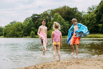 Kids splashing on lakeshore during late spring heatwave