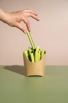 Raw cucumbers sticks in cardboard scoop tray healthy fast food concept