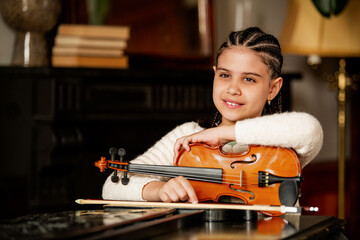 Portrait of a young violinist with instruments