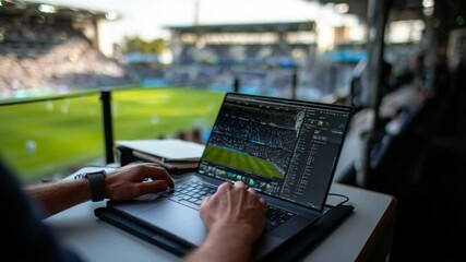 Game Analysis with Technology: A professional uses a laptop to analyze the soccer game during the match. The scene highlights the integration of technology - Powered by Adobe