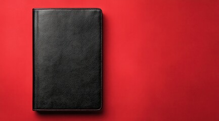 This black leather book cover box is elegantly displayed against a striking red backdrop. The design highlights the sleek texture and craftsmanship, ideal for showcasing product concepts