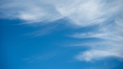 Soft white cirrus clouds against the blue sky on a sunny day. Empty space use for background or backdrop in nature concept