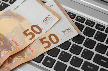 Money cash european union currency on laptop, bank transfer