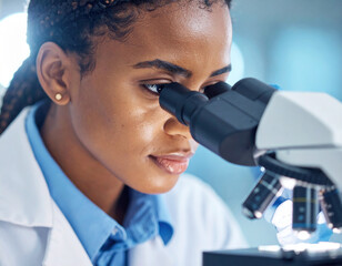 Focused scientist examines sample through microscope, showcasing dedication and precision in her research. bright illumination highlights her concentration and intricate details of her work