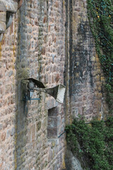 Old loudspeaker mounted on the ancient castle wall conveys history and nostalgia in a rustic setting