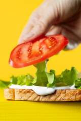 cook put tomato on fresh toasted bread