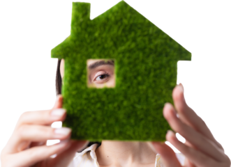 A young girl realtor holds a model of a green house in her hands. Sale of ecological real estate.