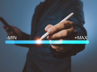 A businessman holding digital pen with glowing light on progress bar showing minimum to maximum concept of growth and improvement