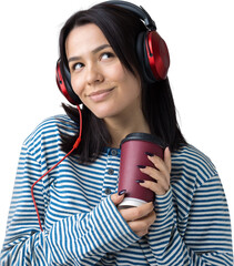 A young girl in a striped vest is listening to music in red headphones in a studio and dancing.