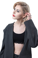 Portrait of a seductive, stylish business lady in the studio. Blonde girl in a suit and top.