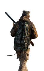 Hunter man in camouflage with a gun during the hunt in search of wild birds or game.