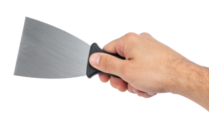 Metallic paint scraper held tightly, transparent backdrop highlighting professional tool prepared for renovation work