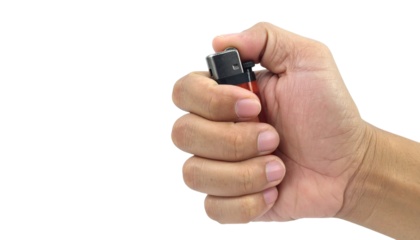 Red lighter being ignited by hand, transparent background, perfect for graphic design and visual compositions