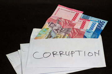 Indonesian Rupiah in 'Corruption' Labeled Envelope