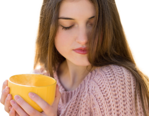 Portrait of pretty young woman in stylish knitted sweater standing with a yellow cup