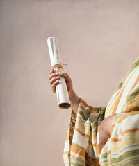 Male hand holding an old scroll
