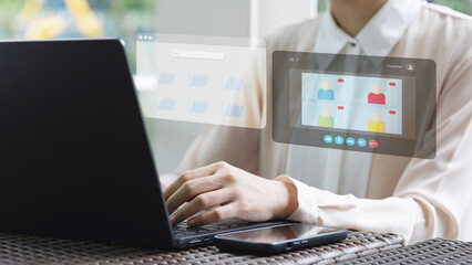 A professional working on a laptop with a digital interface displaying a virtual team profile, multi tasking online meeting.