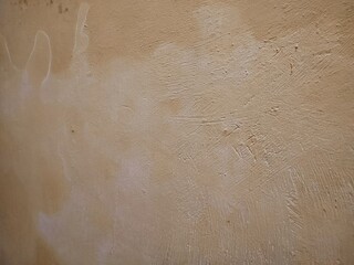 texture, pattern, rough and uneven yellow wall background, creating a lively and abstract background.