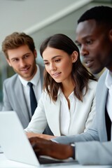 Fototapeta premium Diverse business team collaborating on laptop in office setting