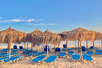 Chaotic sunbeds and palm-leaf umbrellas on Elafonissi beach, Crete, Greece