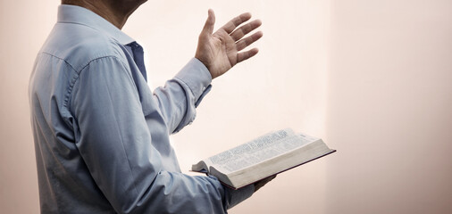 A man with a bible preaches