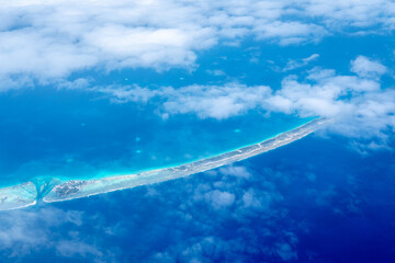 Aerial view of the Tuamotus atoll in French Polynesia with clouds