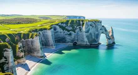 Aerial view of étretat cliffs with natural arch and turquoise sea on a sunny day in normandy france