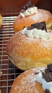 dark chocolate pieces decorate Soft and fluffy Berliner. German Doughnut with swiss chocolate cream inside. High quality