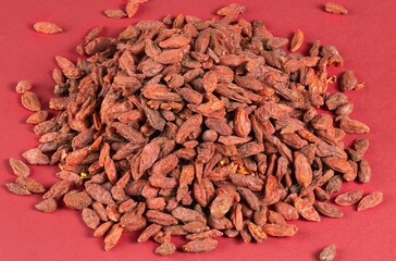 Pile of Dried Goji Berries on Red Background