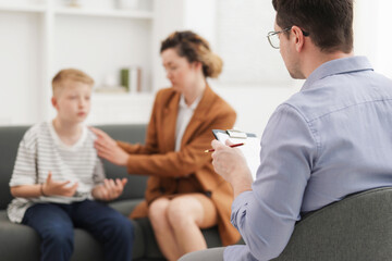 Obraz premium Mother and son having consultation with psychologist in office, selective focus