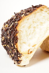 Milk bread with a soft white interior, topped generously with chocolate sprinkles and a touch of white topping. Photographed against a clean white background.