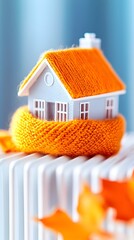 Cozy home model on radiator, winter warmth, energy efficiency, interior