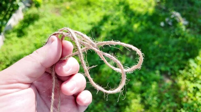 scourge. Texture of Natural Jute Twine. High-resolution texture of natural jute twine, showing its rough fibers and organic weave. scourge in hand. Jute burlap rustic twine string rope cord.