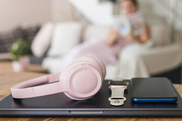 Digital detox during a cozy afternoon at home with headphones and a book in hand