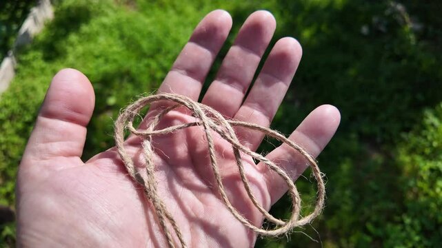 scourge. Texture of Natural Jute Twine. High-resolution texture of natural jute twine, showing its rough fibers and organic weave. scourge in hand. Jute burlap rustic twine string rope cord.