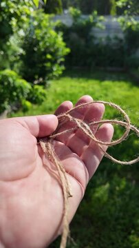 scourge. Texture of Natural Jute Twine. High-resolution texture of natural jute twine, showing its rough fibers and organic weave. scourge in hand. Jute burlap rustic twine string rope cord.
