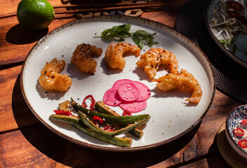 Crispy fried shrimp served with smashed cucumber salad and marinated daikon. Bright and flavorful Vietnamese dish captured in flat lay style