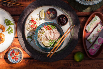 Authentic Vietnamese cuisine including pho bo, spring rolls with shrimp and noodles, fried shrimp,...