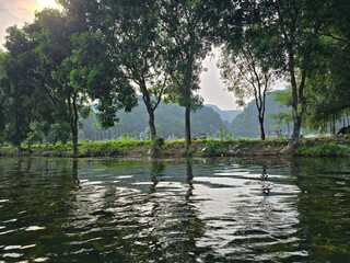 Nunh Binh, Vietnam - October 10, 2025: Trang An Scenic Landscape Complex in Ninh Binh Province, Vietnam - A UNESCO World Heritage Site. A landscape with mountains and lakes