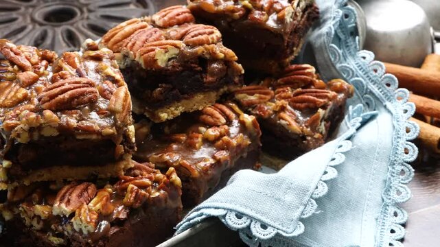 Baking delicious caramel pecan brownies. Panning across the baking pan with caramel pecan brownies. Freshly baked gooey chocolate brownies with sweet caramel and nutty pecans.