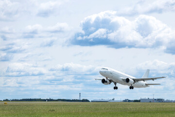 White passenger airplane taking off from Airport Prague, Czechia