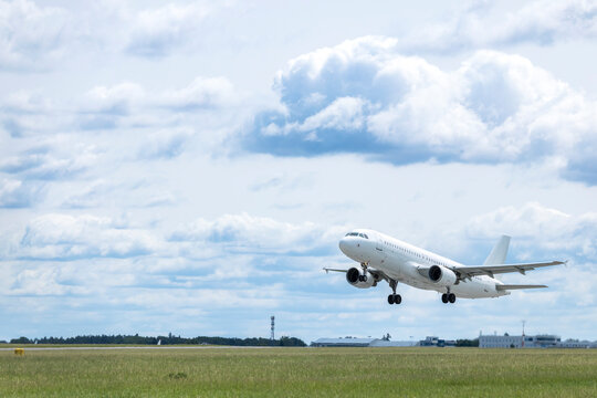 White passenger airplane taking off from Airport Prague, Czechia
