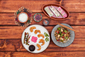 Authentic Vietnamese cuisine including pho bo, spring rolls with shrimp and noodles, fried shrimp, chicken noodles, rice, and pickled vegetables. Flat lays and styled food shots