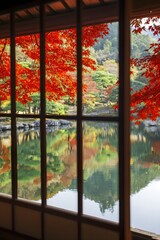 Fototapeta premium Autumn maple leaves reflected in pond seen through shoji screen