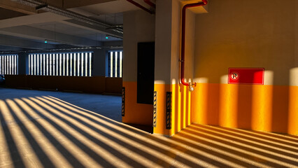 Sunlight beams in a multi-story parking garage.