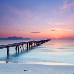 awesome Endless Wooden Pier Stretching Over the Mediterranean Sea at a Vibrant Summer Sunrise